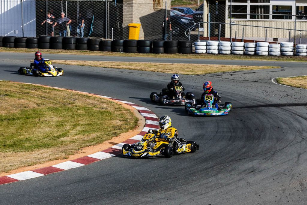4 people enjoying go karting at a work summer party
